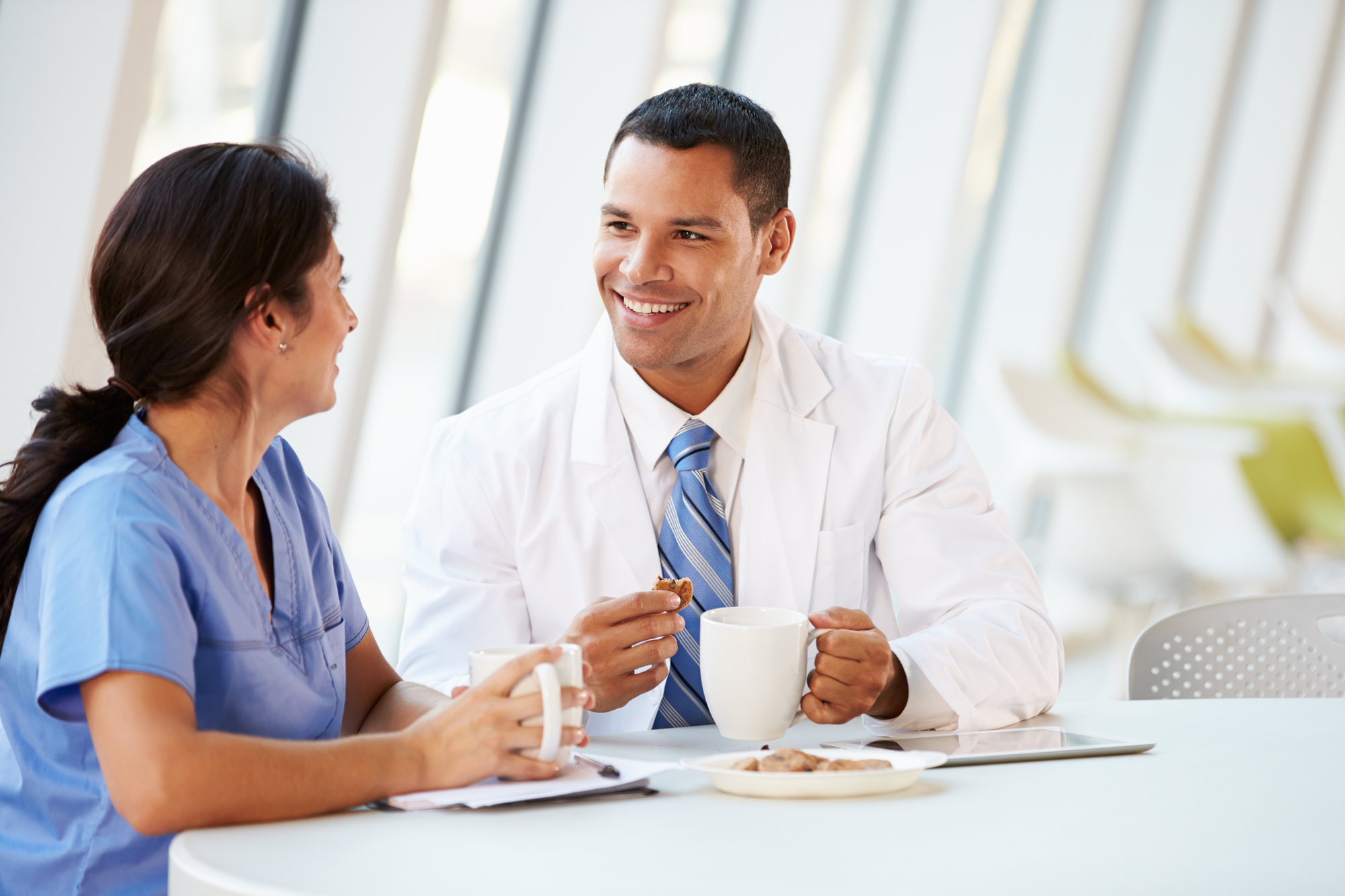 Smiling business person in scrubs speaking with a counselor